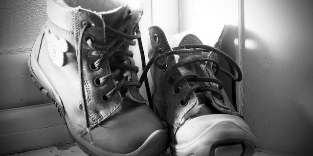 Pair of untied child's shoes on step