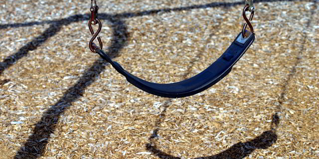 Empty swing in children's playground