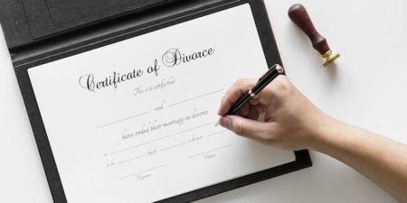 Paperwork for uncontested divorce being signed by Montgomery client